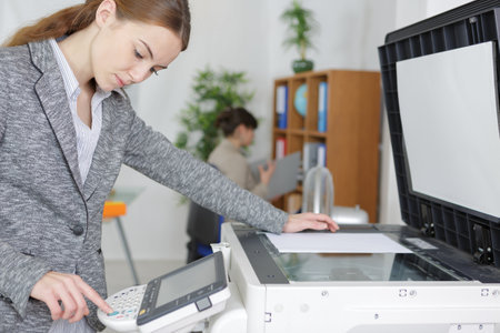beautiful girl operating copy in modern officeの写真素材