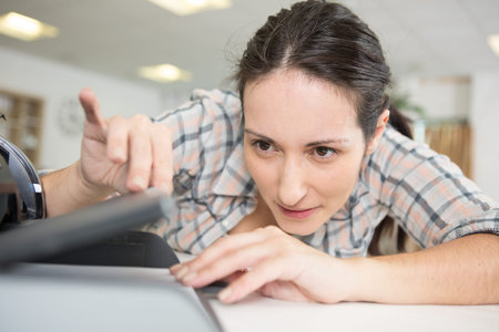 professional woman is fixing a deviceの写真素材