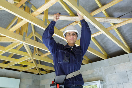female carpenter working on a wood structure