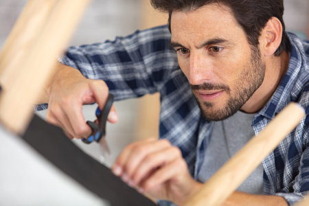 craftsman building wooden chair in workshop