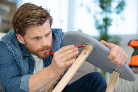 carpenter man marking a small wooden tableの写真素材