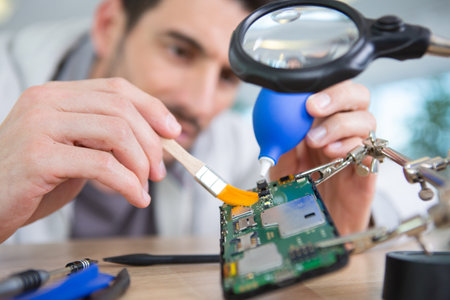 male tech or engineer repairs electronic equipmentの写真素材