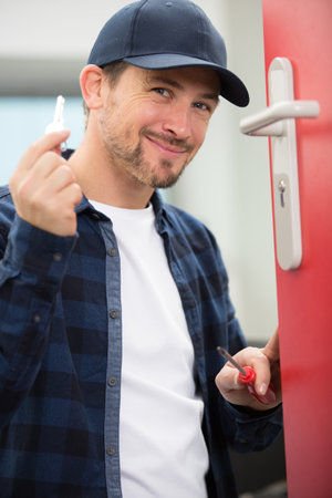 locksmith holding keys for newly fitted lockの写真素材