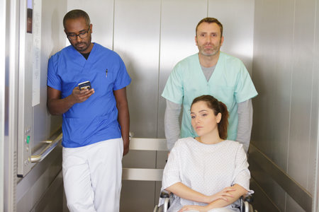 medical team and young woman in wheelchairの写真素材