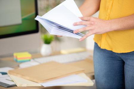 business woman holding stack of documentsの写真素材