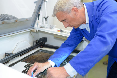 portrait of technician fixing machine