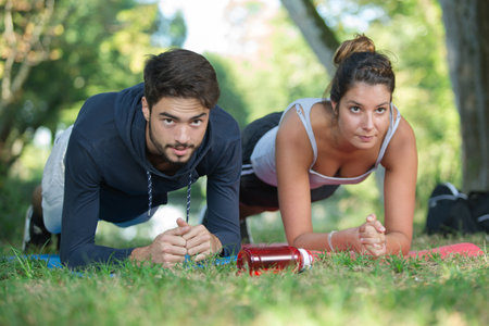 young couple stretching their bodiesの写真素材