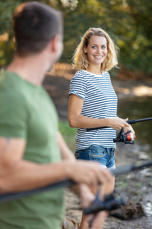 young couple is enjoying fishing on sunny dayの写真素材