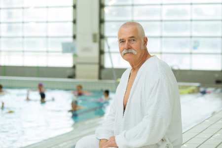 senior man in a bathrobe standing in the spaの写真素材