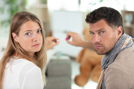 young couple worried because of positive result of ovulation testの写真素材