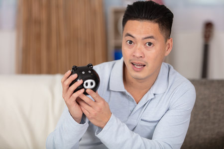 portrait happy man employee holding piggy bank lの写真素材
