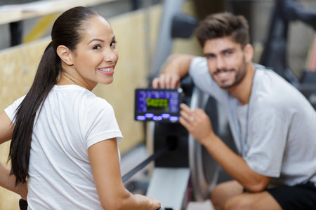 gym class working out on rowing machines togetherの写真素材