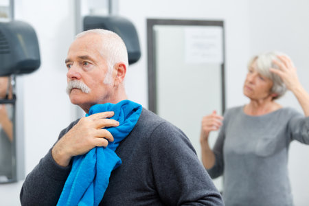 fit senior man in gym resting after working outの写真素材