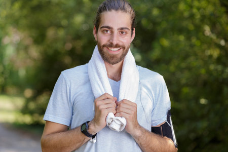 sporty man with a towel in the parkの写真素材