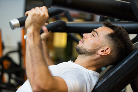 focus picture of man using abs machineの写真素材