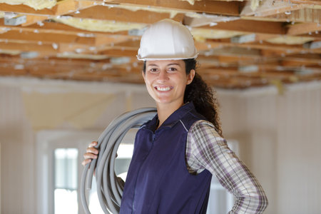 a builder woman holding cablesの写真素材