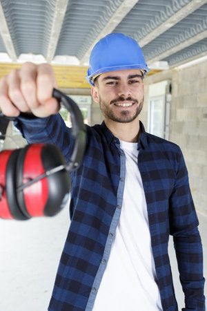 carpenter giving lesson to apprentices about protectionの写真素材
