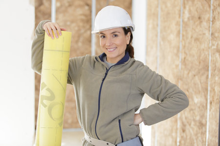 portrait of female worker holding a pipeの写真素材