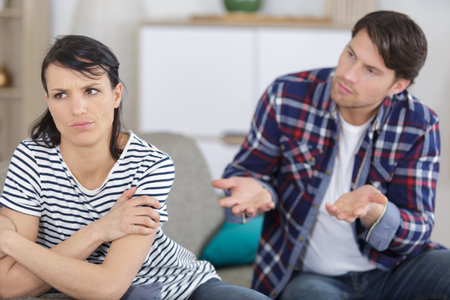 man trying to reconcile with his girlfriend after an argumentの写真素材