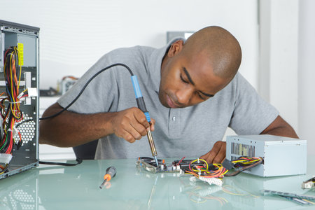 a man during repair of computer hardwareの写真素材