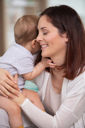 pretty woman holding a newborn baby in her armsの写真素材