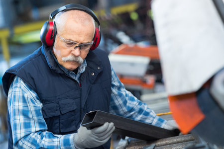 senior worker in metal working machineの写真素材