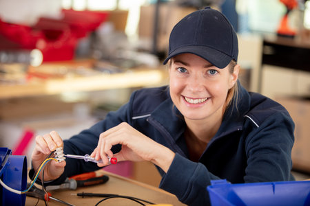 smiling woman measuring electrical currentの写真素材