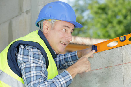 happy builder holding building level