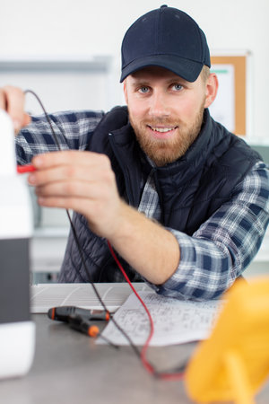 young attractive man trying to repair computerの写真素材