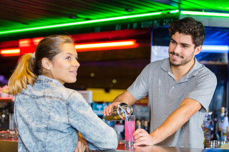 bartender serving female customerの写真素材