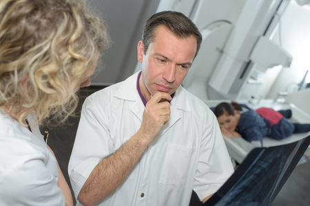 nurse and doctor discussing over xrayの写真素材