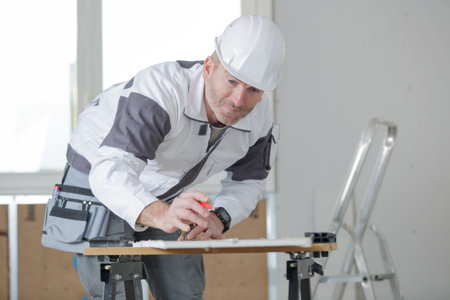 portrait of builder measuring a foam