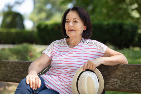 portrait of happy senior woman with hat onの写真素材