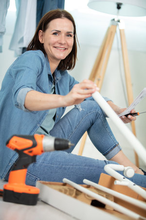 middle aged woman doing diy at homeの写真素材