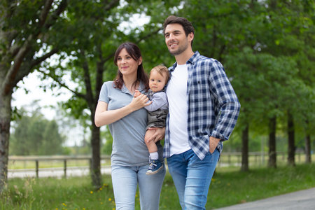 happy family is walking outdoorsの写真素材