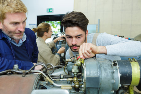 portrait of people working on electrical machineの写真素材