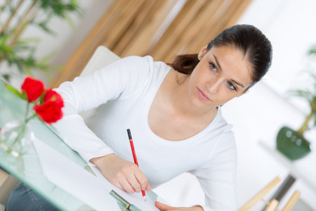 woman drawing on adult coloring bookの写真素材