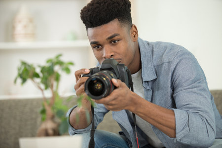 professional photographer using digital camera in his small studioの写真素材