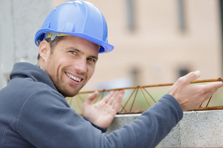 happy builder working with metal support