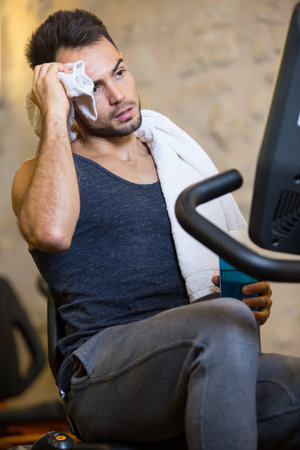 handsome man relaxes in the gymの写真素材