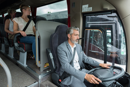 picture of a male bus driver with passengersの写真素材