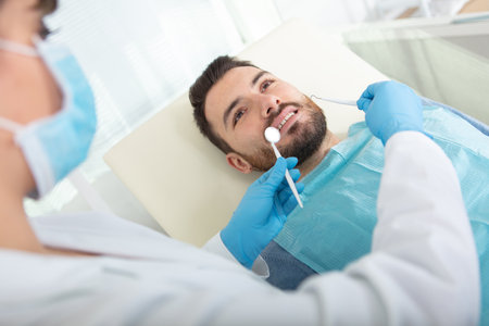 a young male dentist and a patientの写真素材