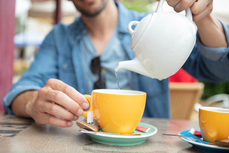 a man pouring green teaの写真素材