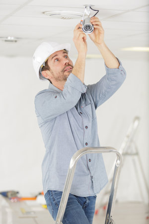 close up of male technician fixing cctv cameraの写真素材