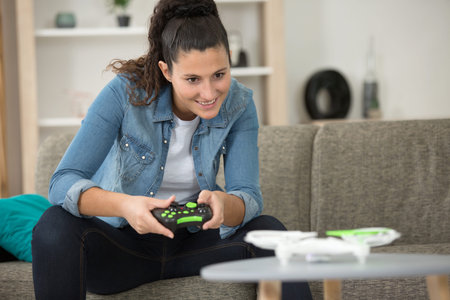 young cute girl playing with a quadcopter