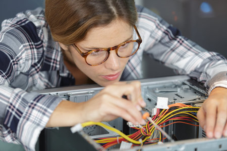 young woman fix pc component in service center