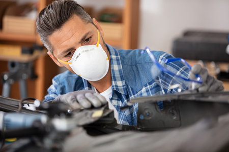 car body worker wearing a dust maskの写真素材