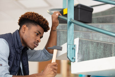 young carpenter working on stairsの写真素材