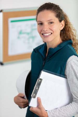 portrait of adult female builder engineer architect inspector