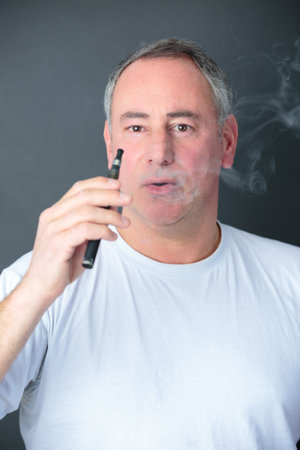 a man smokes an e cigaretteの写真素材
